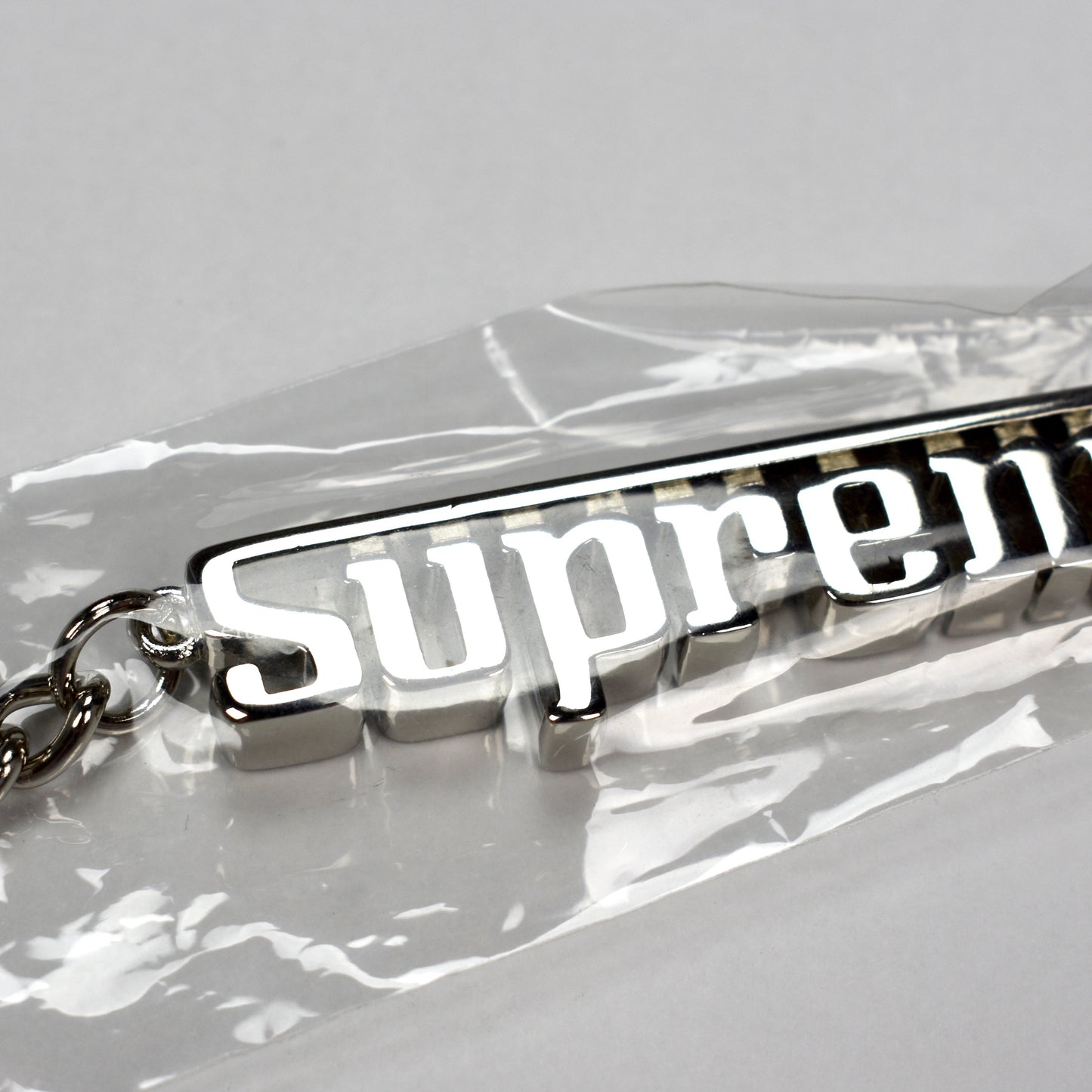 Supreme - Silver Grand Prix Logo Keychain
