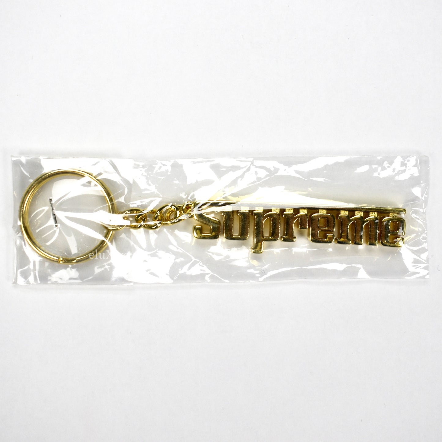 Supreme - Gold Grand Prix Logo Keychain