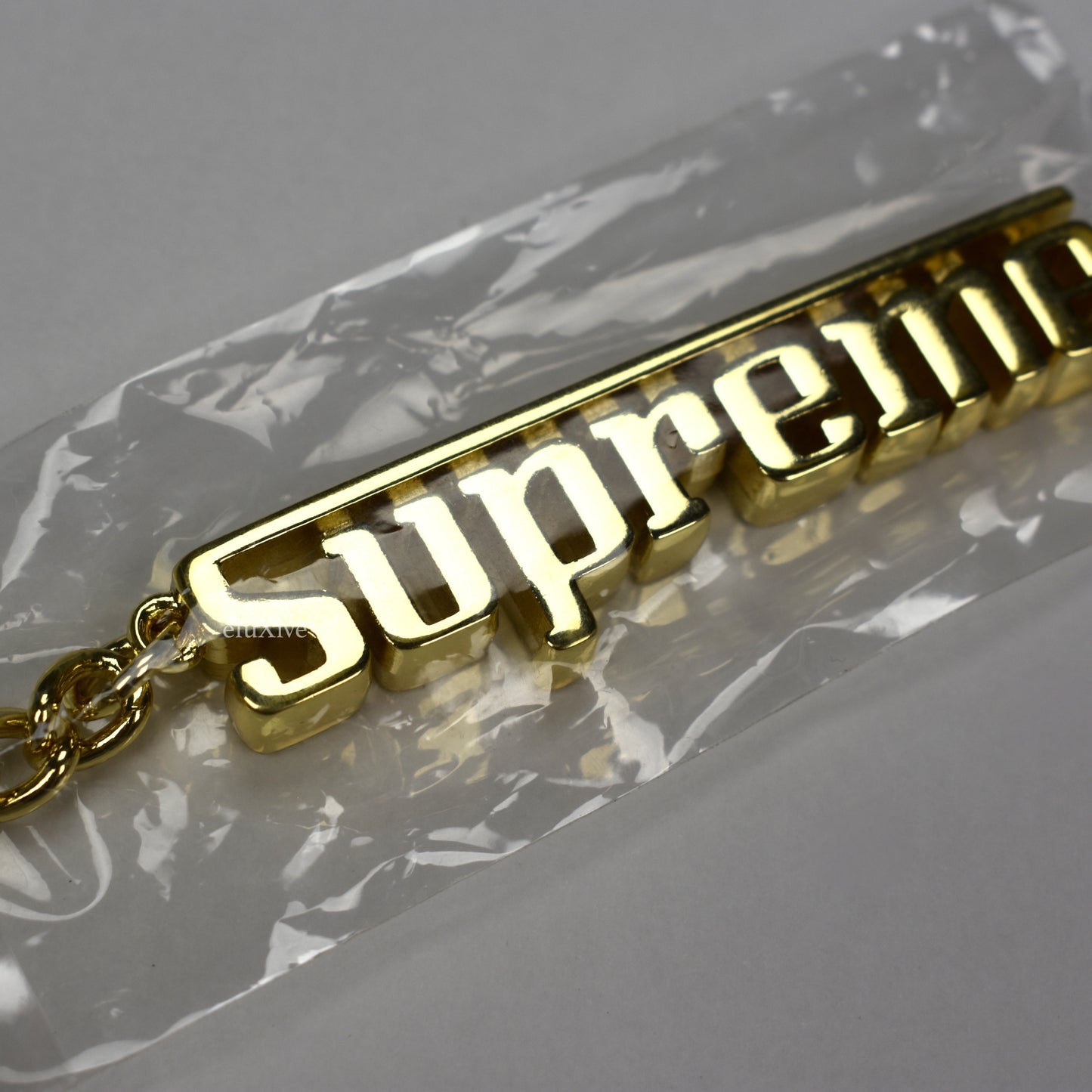 Supreme - Gold Grand Prix Logo Keychain