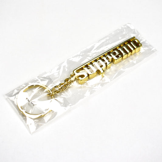 Supreme - Gold Grand Prix Logo Keychain
